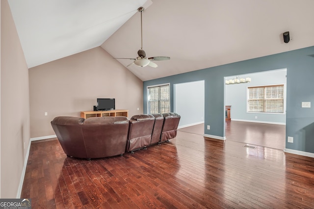 living room with dark hardwood / wood-style flooring, ceiling fan with notable chandelier, and lofted ceiling