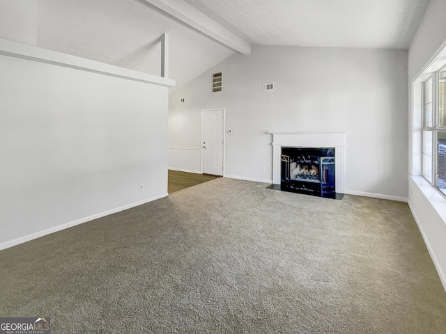 unfurnished living room with dark carpet and vaulted ceiling with beams