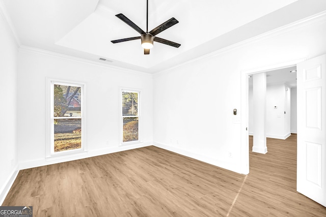 unfurnished room with crown molding, light hardwood / wood-style flooring, and ceiling fan