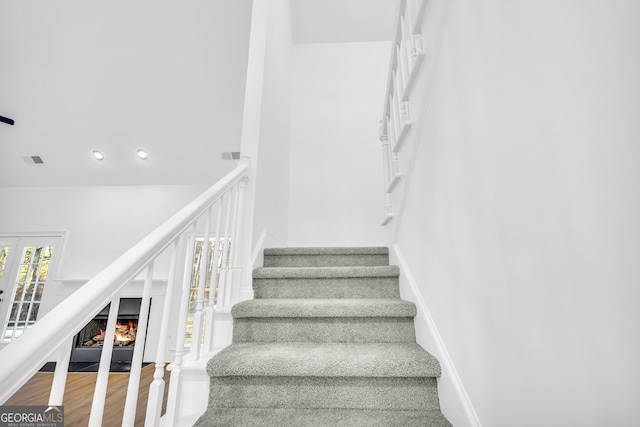 stairs with wood-type flooring