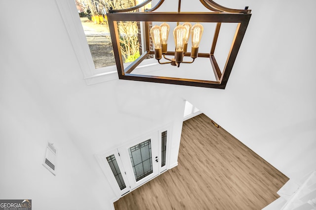 interior space featuring hardwood / wood-style floors and a chandelier