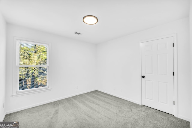 spare room with light colored carpet