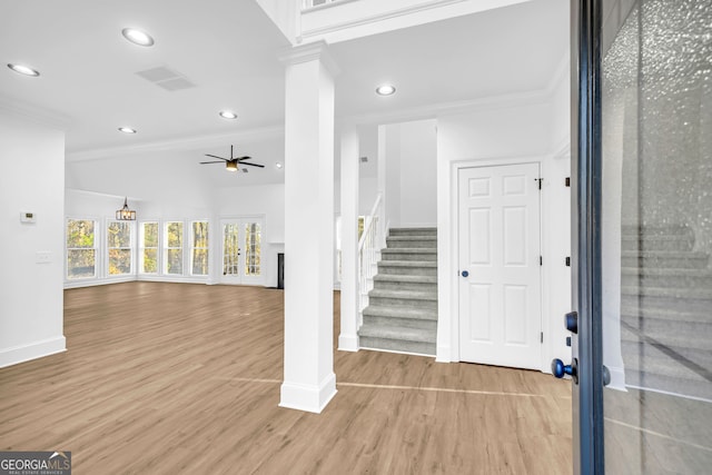 entrance foyer featuring ornate columns, ornamental molding, hardwood / wood-style floors, and ceiling fan