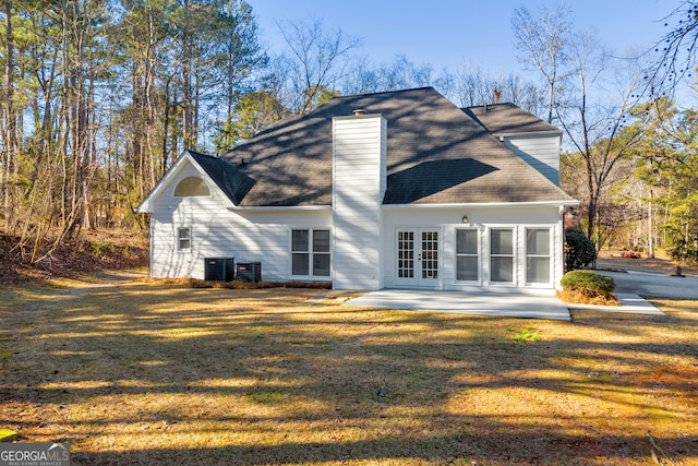 back of house with french doors, a yard, a patio area, and cooling unit