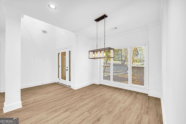 unfurnished dining area featuring hardwood / wood-style flooring and ornamental molding