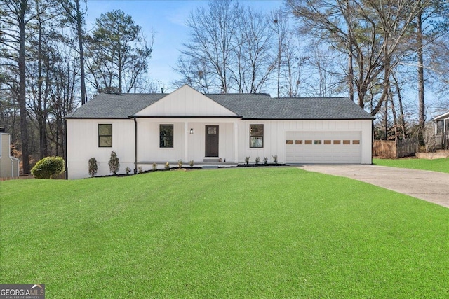 view of front of property featuring a garage and a front yard