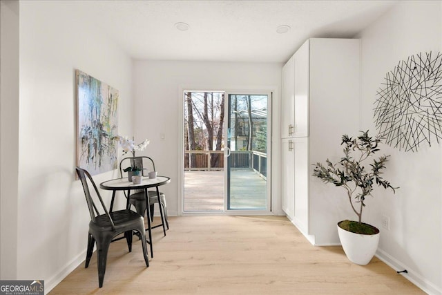 dining space with light hardwood / wood-style floors