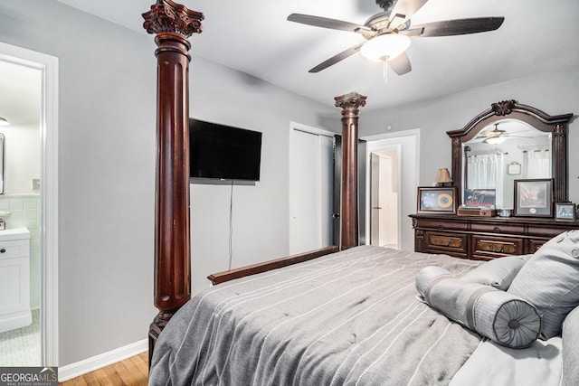 bedroom with ceiling fan, a closet, ensuite bath, and light hardwood / wood-style flooring