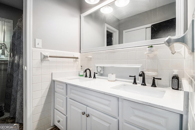 bathroom with vanity and tile walls