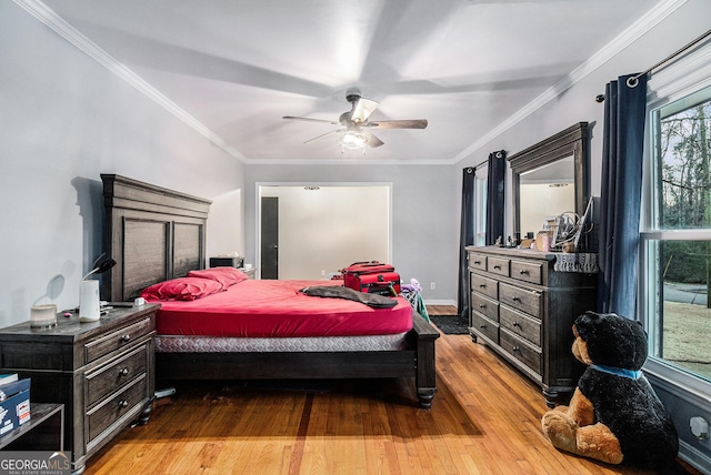 bedroom featuring crown molding, ceiling fan, and light wood-type flooring