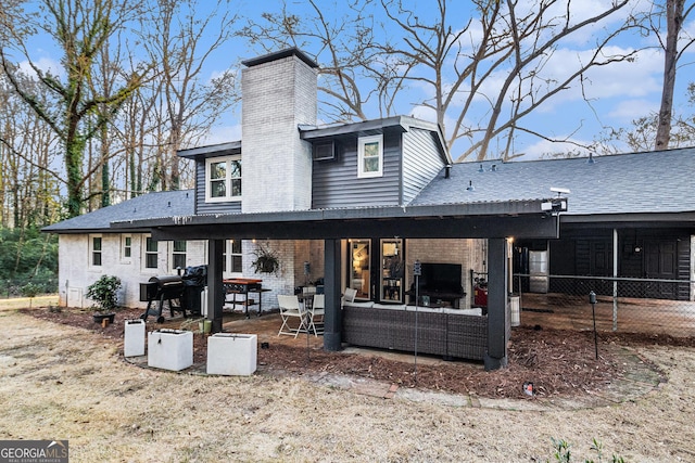 back of property featuring an outdoor living space and a patio