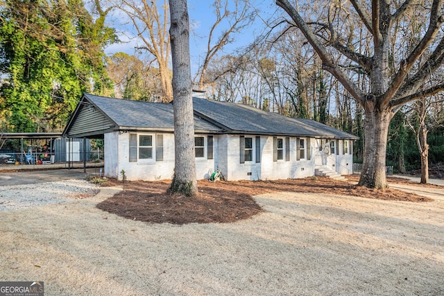 single story home featuring a carport