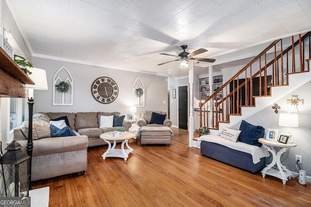 living room with ceiling fan, ornamental molding, and wood-type flooring