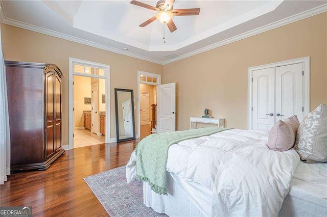 bedroom featuring a raised ceiling, wood-type flooring, crown molding, and ceiling fan