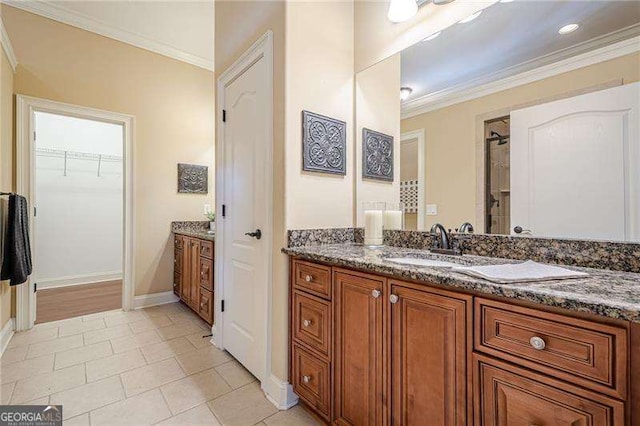 bathroom featuring tile patterned flooring, vanity, and ornamental molding