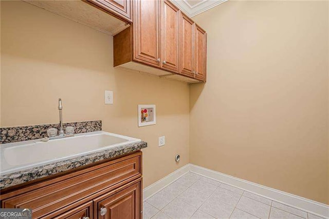 washroom featuring sink, light tile patterned floors, hookup for a washing machine, cabinets, and hookup for an electric dryer