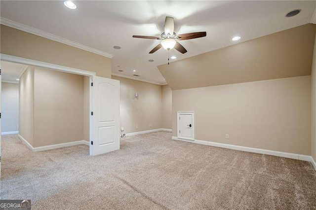 interior space featuring ceiling fan, light colored carpet, and lofted ceiling