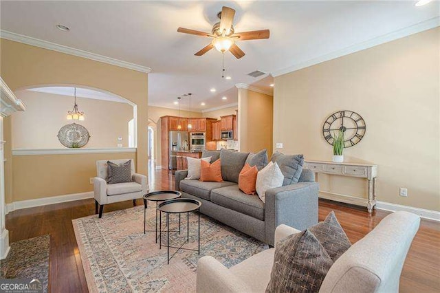 living room featuring crown molding, dark hardwood / wood-style floors, and ceiling fan