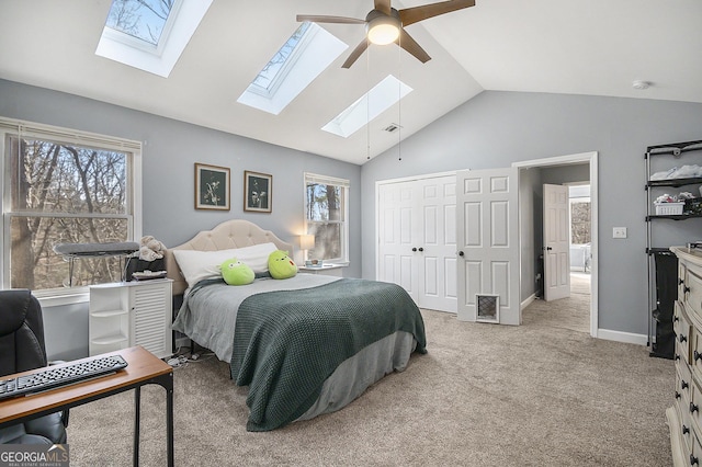 carpeted bedroom with vaulted ceiling, ceiling fan, and a closet