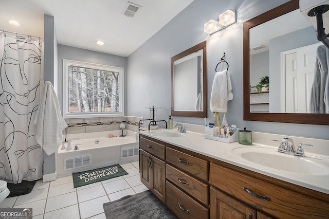 bathroom featuring tile patterned flooring, vanity, and separate shower and tub