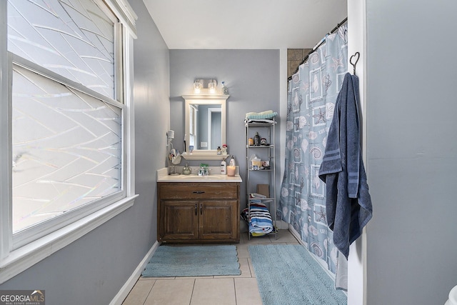 bathroom with a shower with curtain, tile patterned floors, and vanity