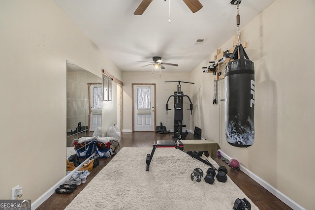 exercise area featuring dark wood-type flooring