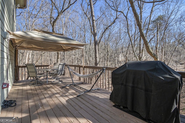 wooden terrace featuring grilling area