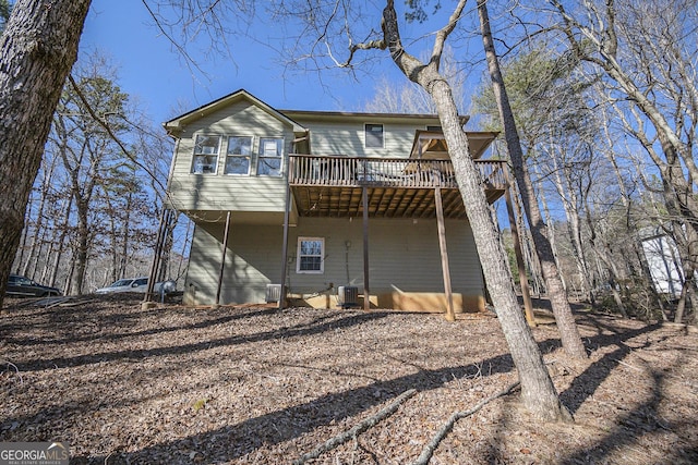 back of property featuring a wooden deck