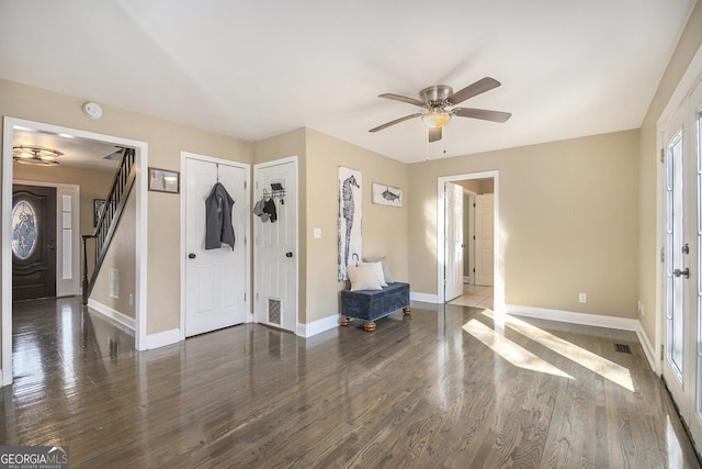 entryway with dark wood-type flooring and ceiling fan