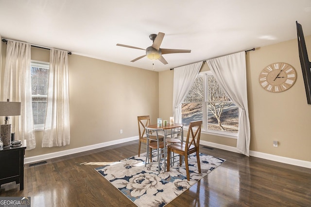 dining space featuring dark hardwood / wood-style floors and ceiling fan