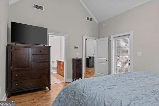 bedroom with connected bathroom, ornamental molding, light hardwood / wood-style floors, and high vaulted ceiling