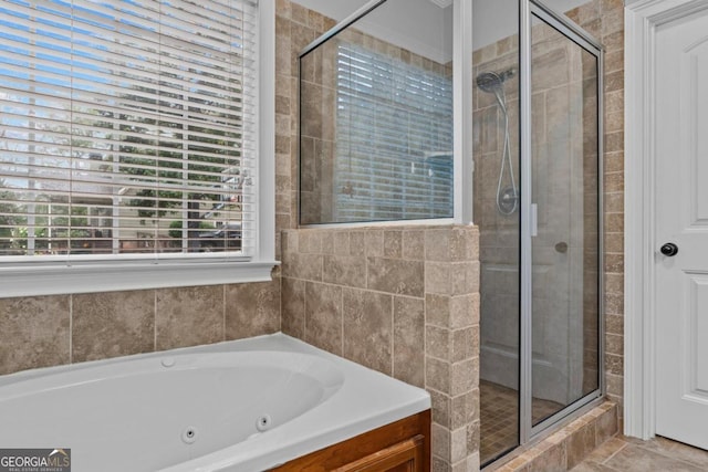 bathroom featuring tile patterned flooring and shower with separate bathtub