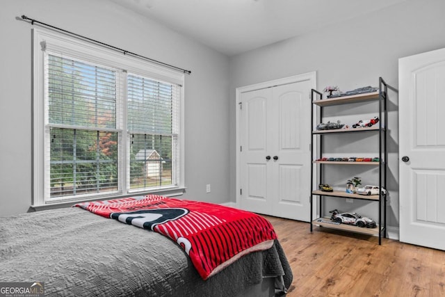 bedroom featuring a closet and light wood-type flooring