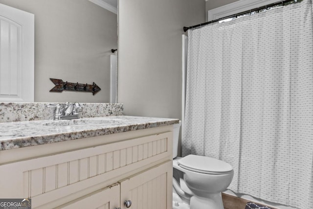 bathroom featuring crown molding, vanity, toilet, and a shower with shower curtain