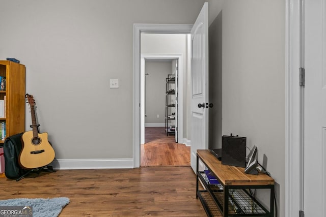 hallway with dark hardwood / wood-style floors