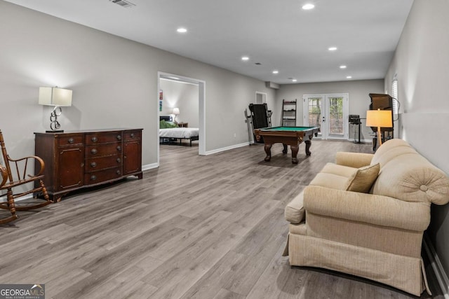 game room with french doors, pool table, and light wood-type flooring