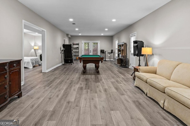 recreation room with pool table, light wood-type flooring, and french doors