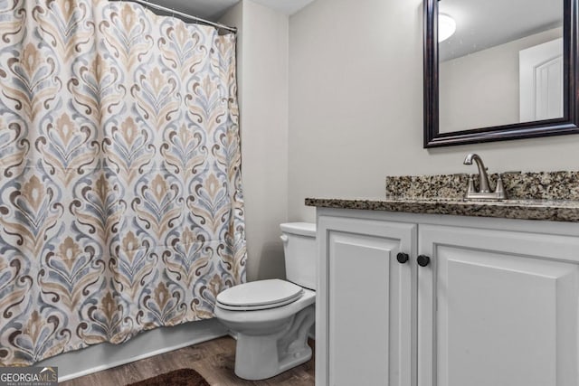 bathroom featuring vanity, hardwood / wood-style flooring, and toilet