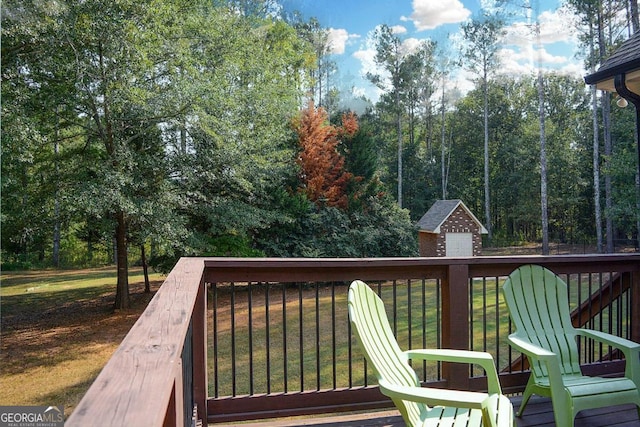 wooden terrace featuring a lawn