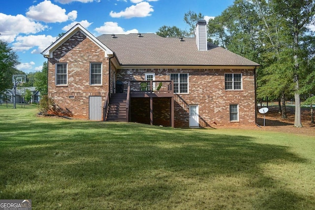 rear view of house with a deck and a lawn