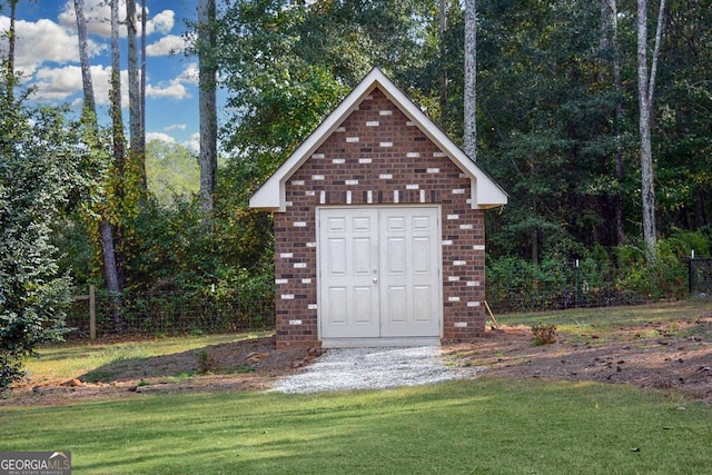 view of outdoor structure featuring a lawn