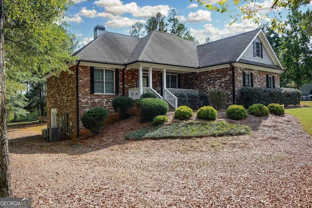 front of property featuring cooling unit and covered porch