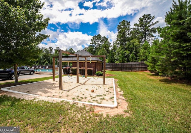 view of playground with a lawn