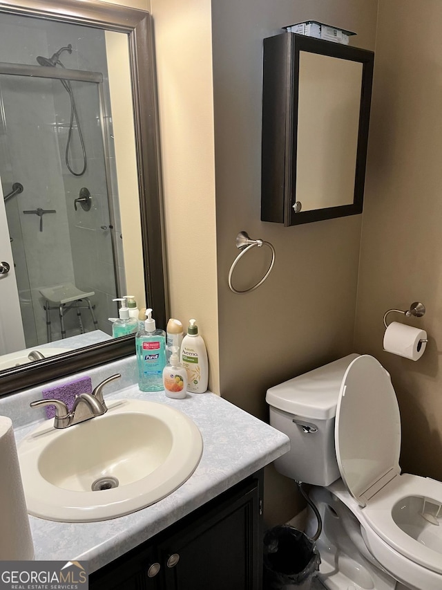 bathroom featuring walk in shower, vanity, and toilet