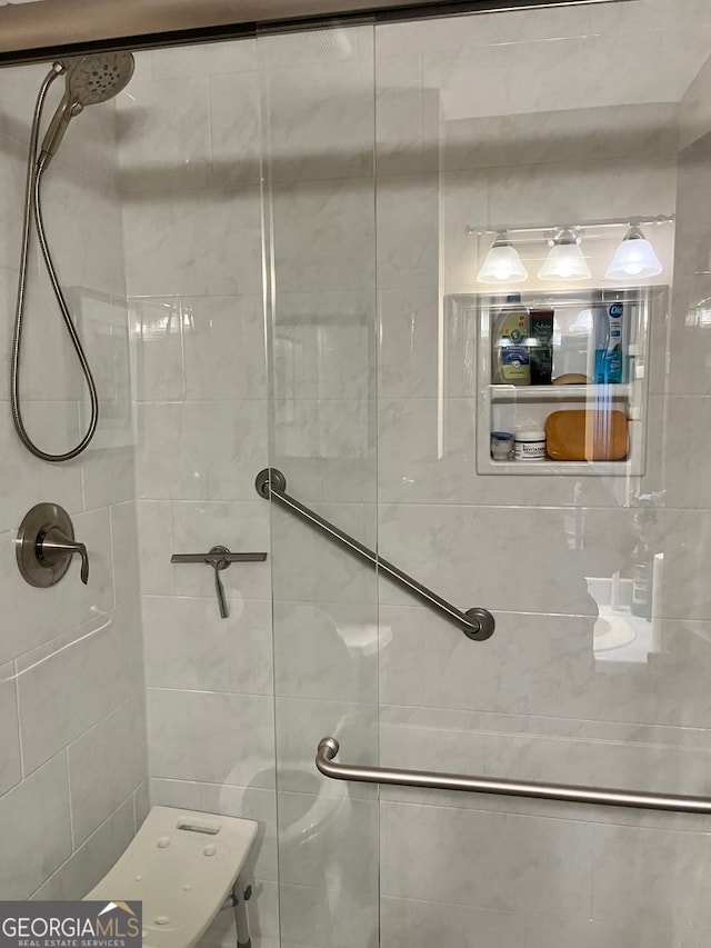 bathroom with a shower with door