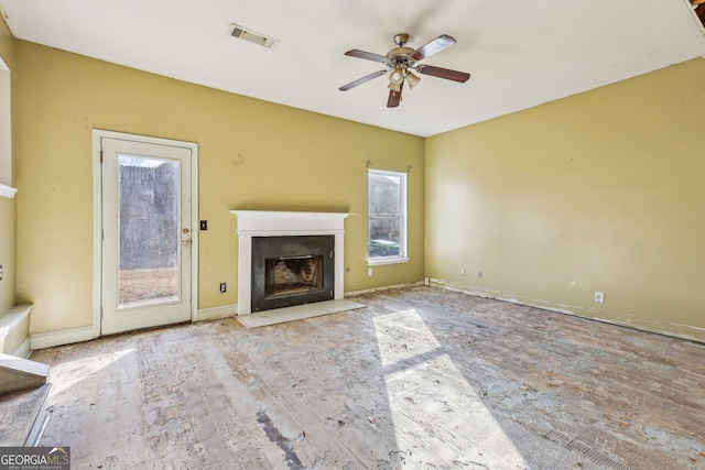 unfurnished living room with ceiling fan