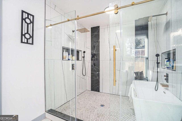 bathroom featuring shower with separate bathtub