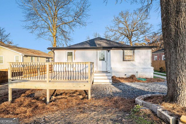 back of property with a wooden deck