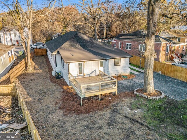 rear view of house featuring a deck