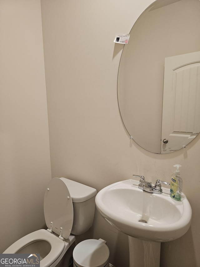 bathroom featuring sink and toilet